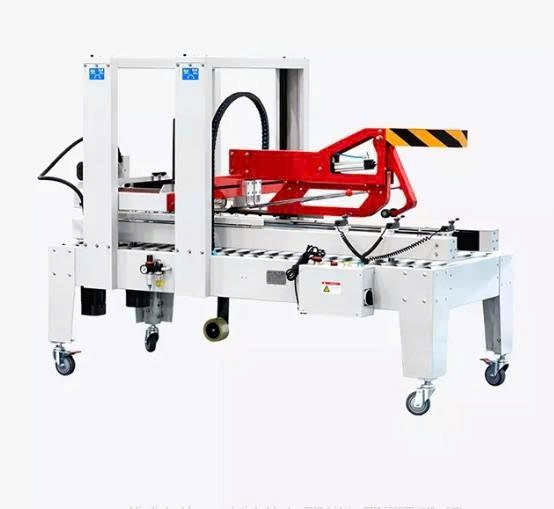 máy dán băng keo thùng carton (dùng cho băng keo pvc) hualian fxj-5050zb hình 1 may dan bang keo thung carton (dung cho bang keo pvc) hualian fxj-5050zb hinh 1